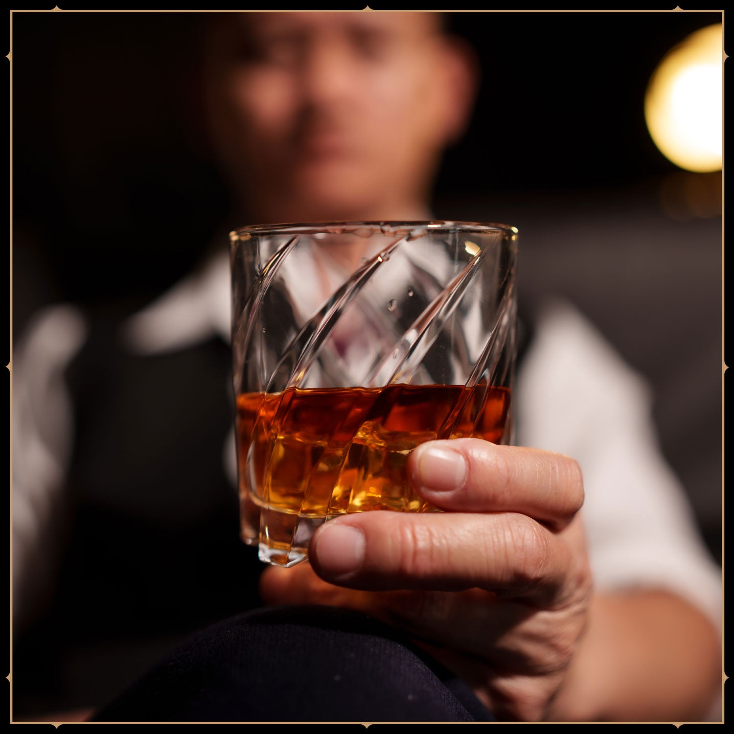 SFR Legendary Club image of a man holding a glass of Whisky.